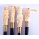 FOUR UNUSUAL CONTINENTAL CARVED BONE WALKING CANES with wooden shafts. 92 cm long.