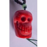 A CHINESE CORAL SKULL NECKLACE. 2.5 cm long.
