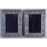 A PAIR OF SILVER AND ENAMEL PHOTOGRAPH FRAMES. 19 cm x 4 cm.