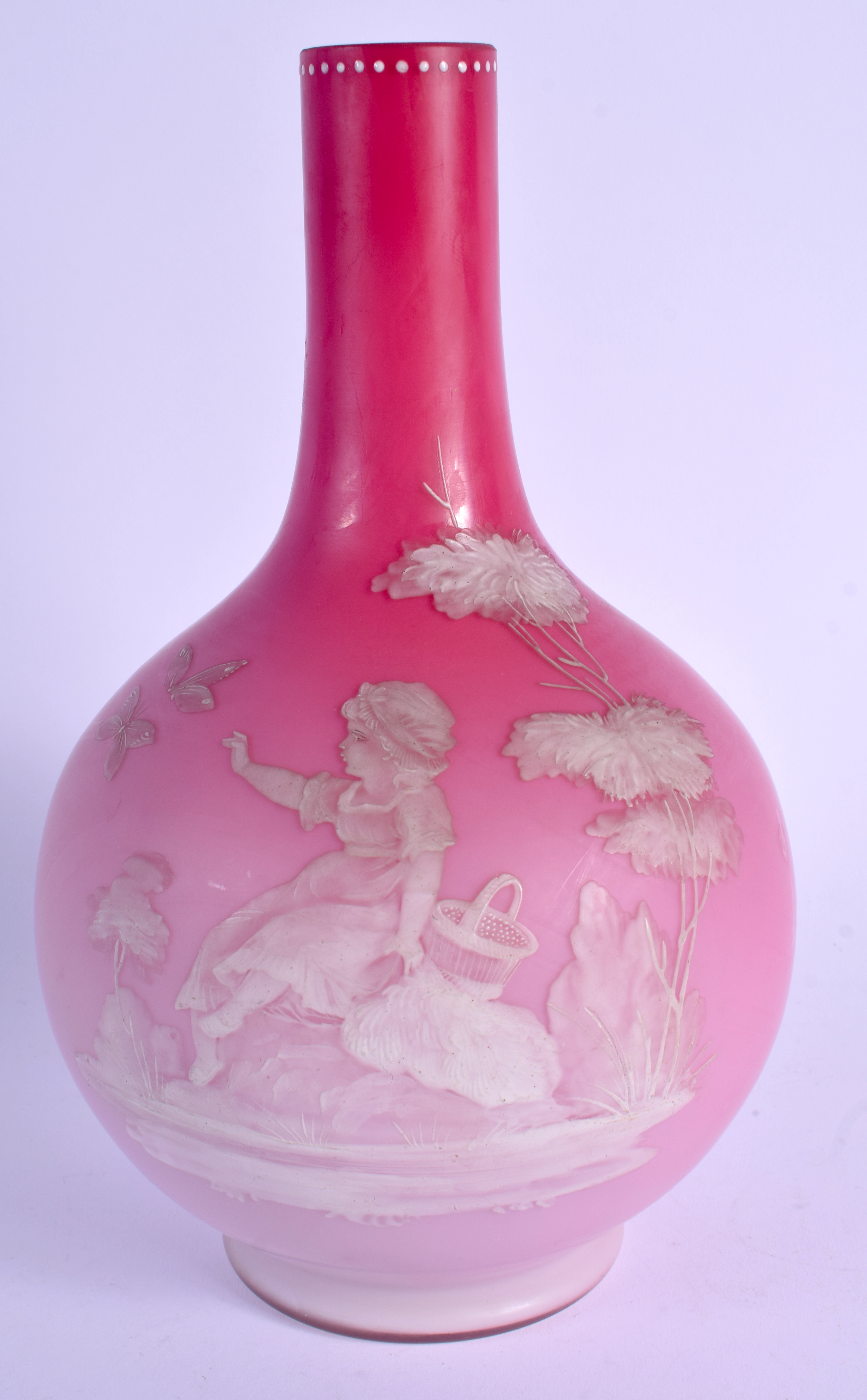 A LATE VICTORIAN PINK OPALINE GLASS VASE enamelled with a girl seated beside butterflies. 24 cm high