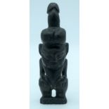 A Chinese hard stone statue of a male with a penis on his head 26 x 7cm.