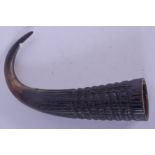 A 19TH CENTURY CONTINENTAL CARVED HORN FINGER GUARD. 9 cm wide.