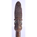 A LARGE MAORI CARVED WOOD STAFF Taiaha, with shell inset eyes and carved zig zag spiralised motifs.