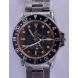 A VINTAGE ROLEX GMT MASTER BLACK DIAL WRISTWATCH with stainless steel strap, t25 mark to underside o