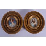 A PAIR OF EARLY 20TH CENTURY CONTINENTAL PAINTED IVORY PORTRAIT MINIATURES within green velvet frame