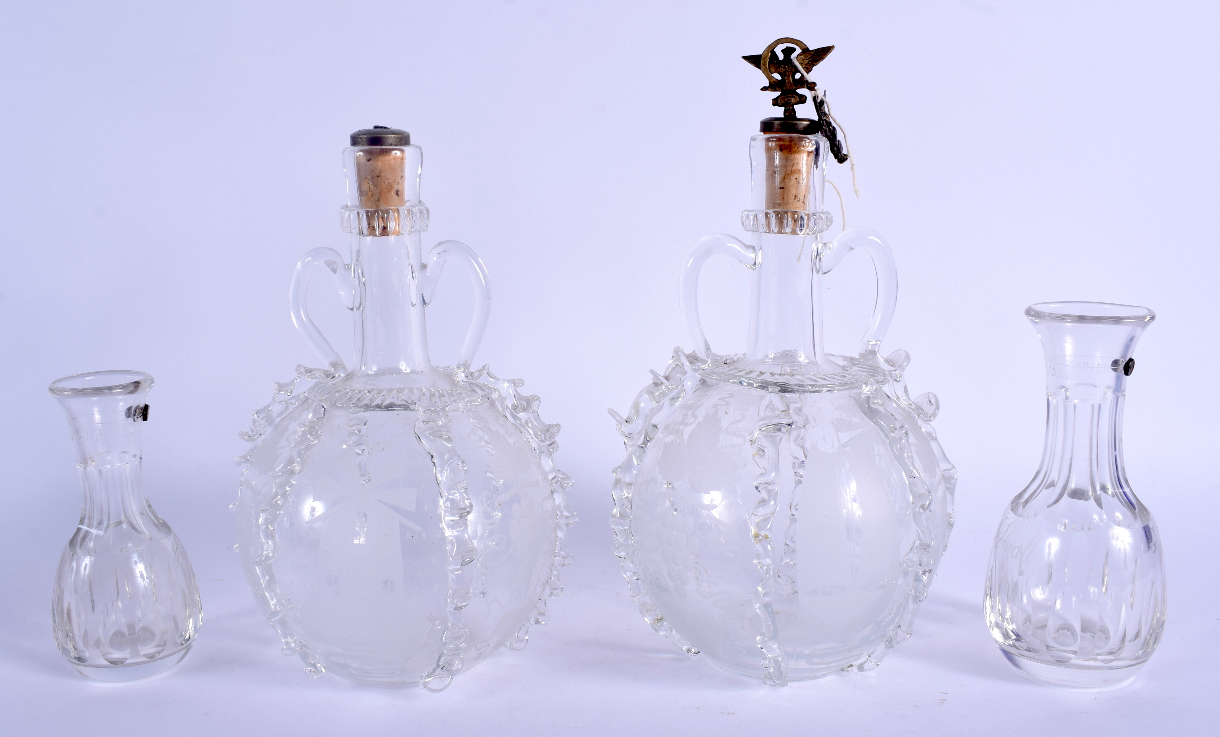 A PAIR OF 19TH CENTURY GLASS DECANTERS together with a pair of Richardson's patent ½ gill bottles. L