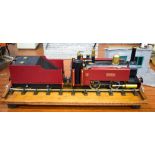 A BOXED LOCOMOTIVE TRAIN Robin, with tender, upon an oak track. 36 cm long, wheel 3 cm diameter. (3)