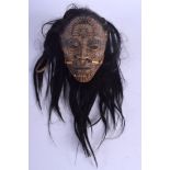 AN UNUSUAL TRIBAL CARVED AND LACQUERED HEAD OF A LEADER possibly Maori or South American, with tatto