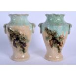 AN UNUSUAL PAIR OF EARLY 20TH CENTURY JAPANESE TAISHO PERIOD VASES decorated with figures within lan