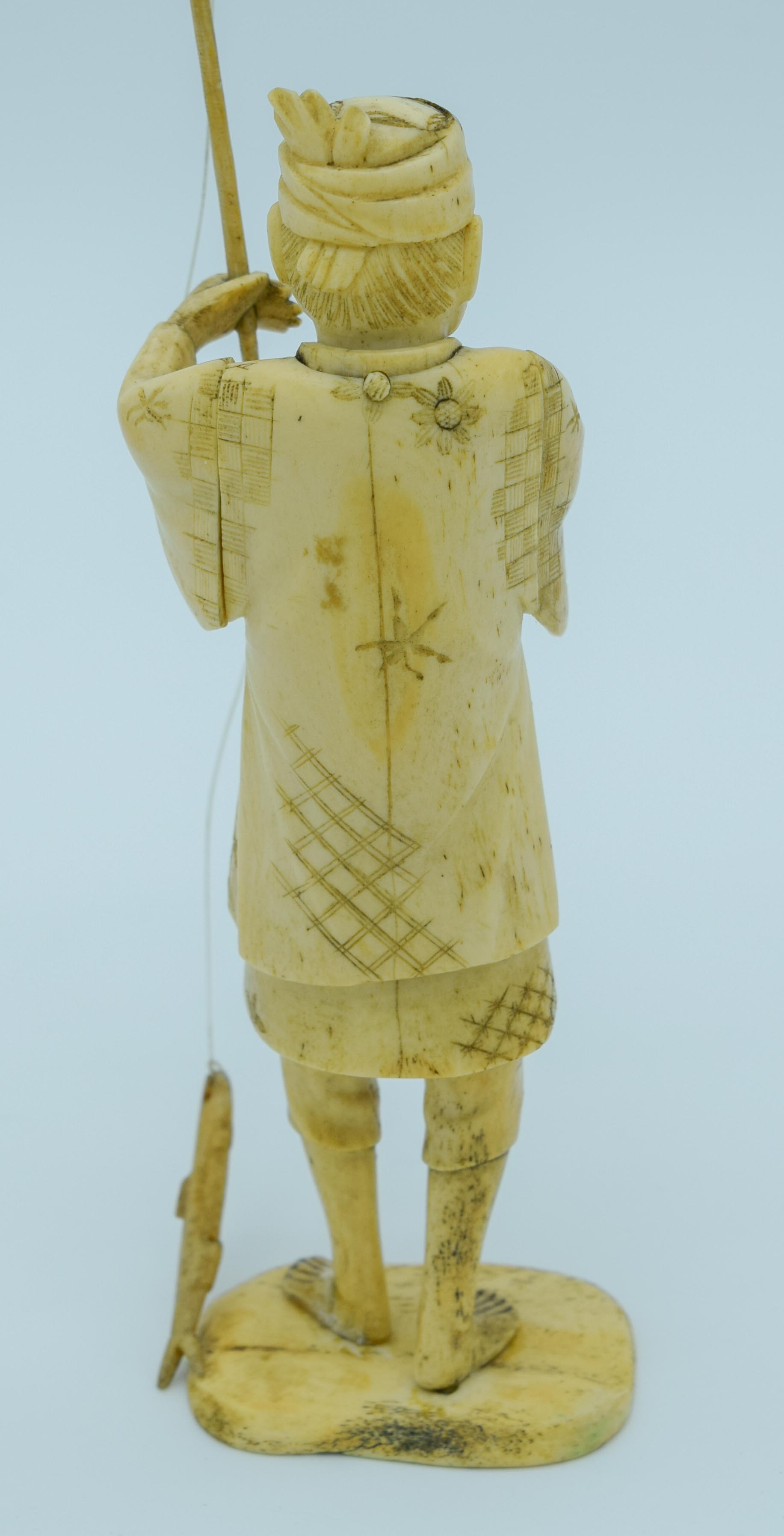 A small Japanese Meiji Period Ivory figure of a fisherman 20cm . - Image 2 of 2