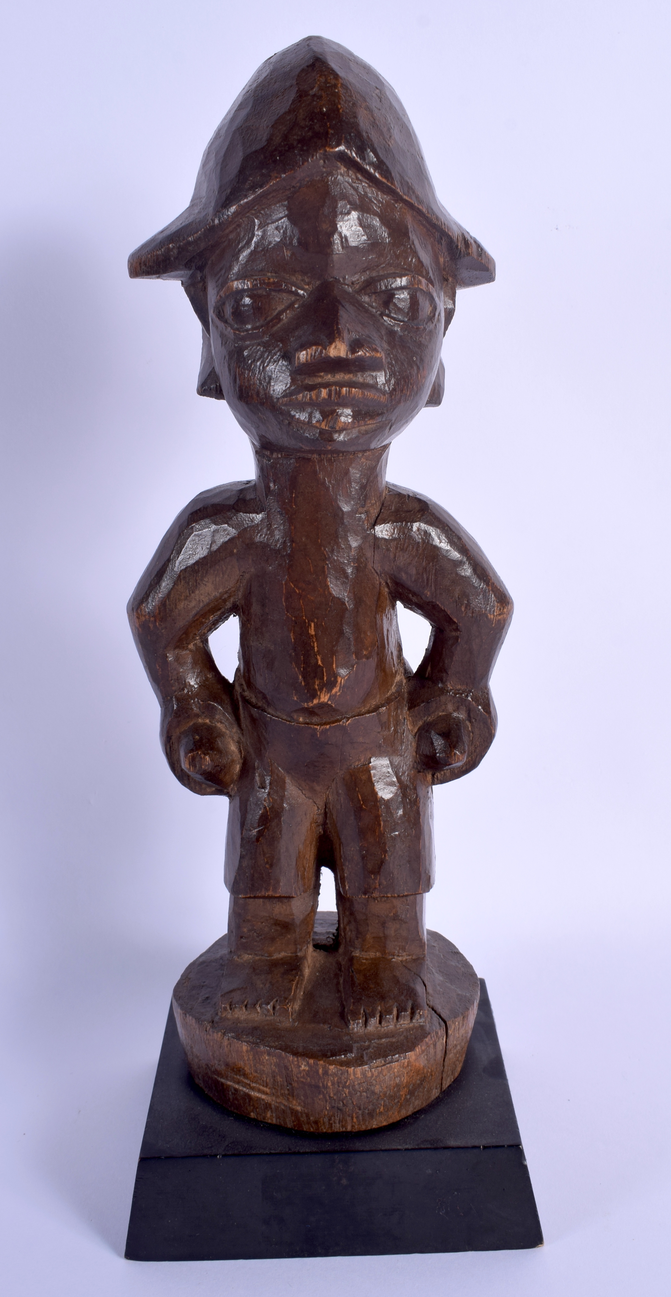 AN AFRICAN TRIBAL YORUBA HARDWOOD FIGURE. 29 cm high overall.