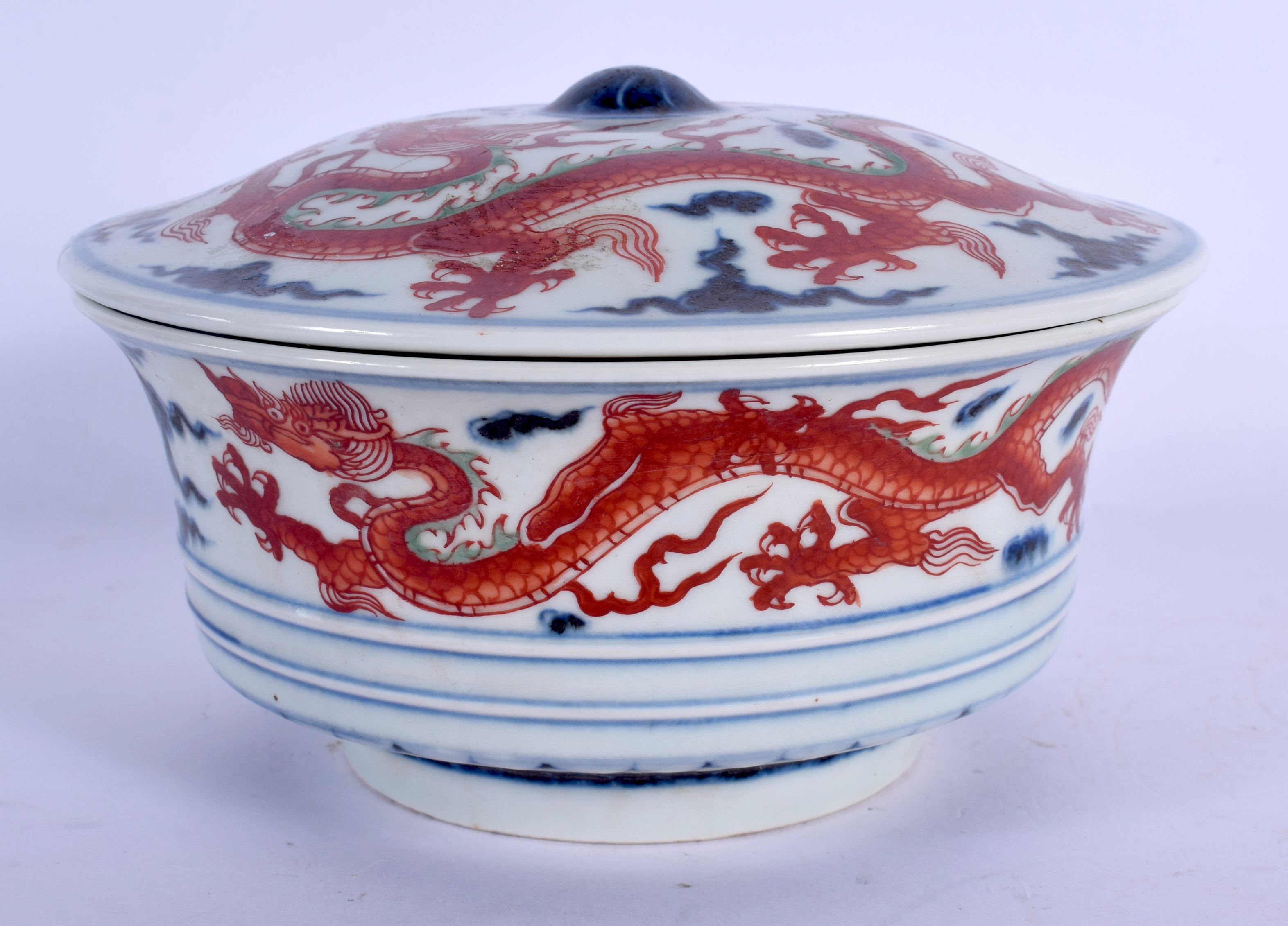 A CHINESE BLUE AND WHITE PORCELAIN BOWL AND COVER 20th Century, painted with dragons amongst clouds.