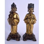 A PAIR OF 17TH CENTURY CHINESE GILT BRONZE IMMORTALS Ming, modelled as attendants upon polychromed b