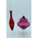 A quality Cranberry glass lidded bowl with interior ribbing and a Ruby glass decanter largest 49cm