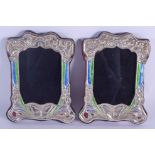 A PAIR OF SILVER AND ENAMEL PHOTOGRAPH FRAMES. 19 cm x 14 cm.