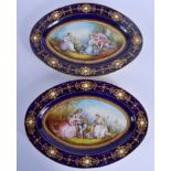 A LARGE PAIR OF 19TH CENTURY FRENCH SEVRES PORCELAIN DISHES painted with lovers in a landscape. 30 c