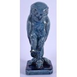 A 19TH CENTURY SCOTTISH BLUE GLAZED POTTERY OF A AN OWL modelled standing upon three mice. 20 cm hig