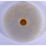 A CHINESE CARVED WHITE JADE TABLET 20th Century. 5.5 cm diameter.