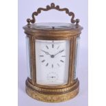 A 19TH CENTURY FRENCH REPEATING ALARM CARRIAGE CLOCK of oval form, engraved with foliage and vines.