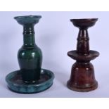 TWO 19TH CENTURY CHINESE POTTERY BUDDHISTIC POTTERY CANDLESTICKS. Largest 20 cm high. (2)