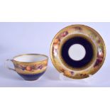 A ROYAL WORCESTER TEACUP AND SAUCER painted with a band of fruit on a mossy bank above a blue and gi