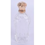 AN 18CT GOLD MOUNTED GLASS SCENT BOTTLE. 9 cm high.