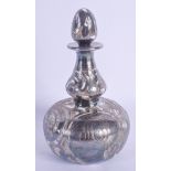 AN ART NOUVEAU SILVER OVERLAID SCENT BOTTLE AND STOPPER overlaid with scrolls. 14.5 cm high.