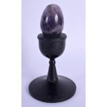 A BLUEJOHN AMETHYST EGG upon a stand. 12 cm high.