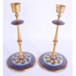 A PAIR OF 19TH CENTURY FRENCH BRASS AND ENAMEL CANDLESTICKS embellished with motifs. 24 cm high.