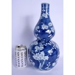 A 19TH CENTURY CHINESE BLUE AND WHITE DOUBLE GOURD VASE bearing Kangxi marks to base. 33 cm high.