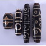 FOUR CHINESE TIBETAN AGATE BEADS 20th Century. Largest 7 cm long. (4)