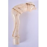 A VERY RARE EARLY 19TH CENTURY CARVED BONE CANE HANDLE modelled as a snuff taker. 13.5 cm long.