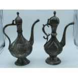 Two Middle Eastern metal embossed Ewers