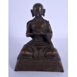 A CHINESE TIBETAN BRONZE FIGURE OF A SEATED BUDDHA 20th Century, modelled with hands clasped. 16 cm