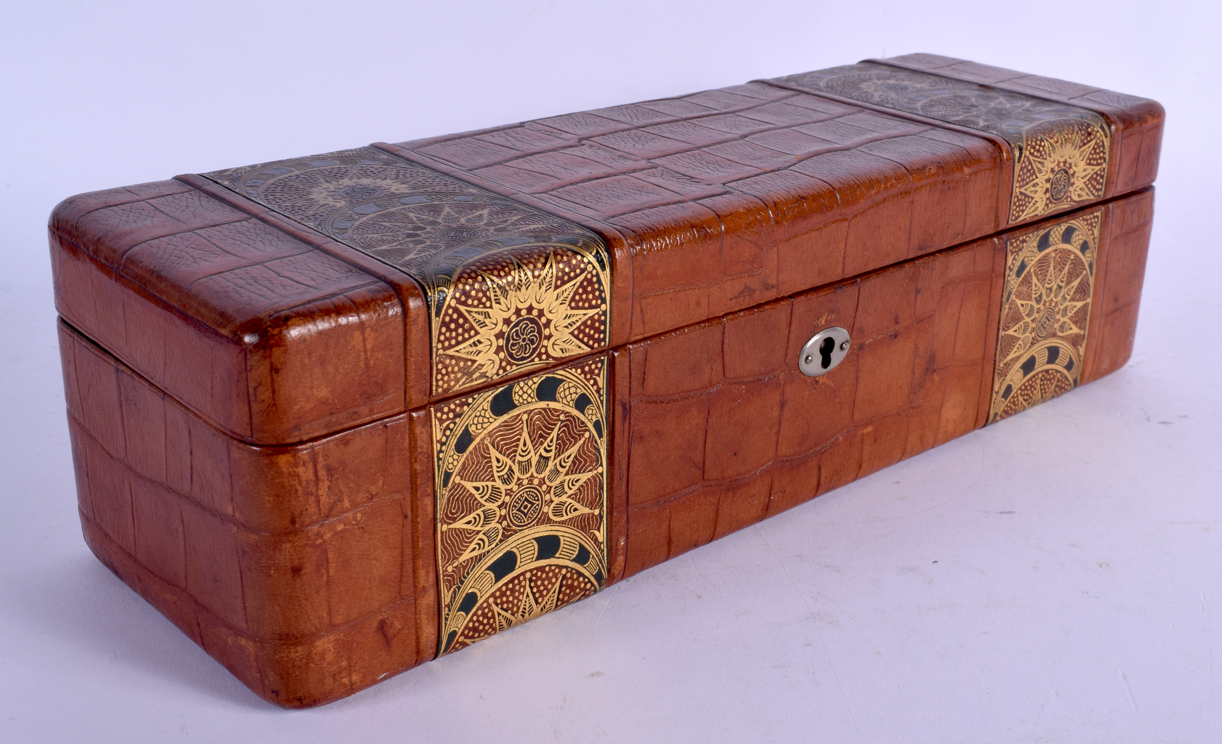 AN EARLY 20TH CENTURY CONTINENTAL LEATHER BOX with secessionist inspired decoration. 30 cm x 9 cm.