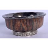 A 19TH CENTURY CHINESE TIBETAN CARVED WOOD AND SILVER BOWL. 9.5 cm diameter.