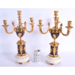 A LARGE PAIR OF 19TH CENTURY FRENCH EGYPTIAN REVIVAL BRONZE CANDLESTICKS decorated with figures and
