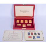 A SET OF CORONATION ISSUE GOLD PLATED SILVER STAMPS. (7)