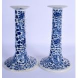 A PAIR OF 19TH CENTURY CHINESE BLUE AND WHITE PORCELAIN CANDLESTICKS Qing, painted with dragons amon