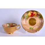 A ROYAL WORCESTER CUP AND SAUCER, the cup painted inside and with gold outside, both with fruit by M
