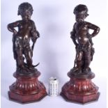 A LARGE PAIR OF 19TH CENTURY FRENCH BRONZE FIGURES modelled upon red marble bases. 56 cm high.