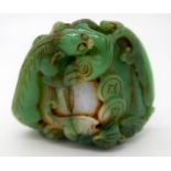 A carved jade bolder decorated with foliage and reptiles 6 x 6 cm.