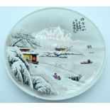 A Chinese plate celebrating 1973 decorated with a snowy landscape.