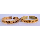 AN UNUSUAL PAIR OF 18TH/19TH CENTURY CHINESE GILT BRONZE BANGLES Qing, decorated with figures and la