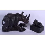 AN AFRICAN CARVED HARDWOOD FIGURE OF A RHINOCEROS together with an ebony elephant box. Largest 24 cm