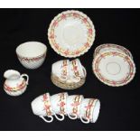 A part Tea set possibly Staffordshire decorated with pink flowers and pink branches .(Qty)