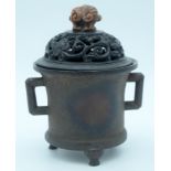 A 19th century bronze incense burner with a carved wooden and soapstone lid 17 x 14cm