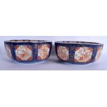 A LARGE PAIR OF 19TH JAPANESE MEIJI PERIOD IMARI OCTAGONAL BOWLS painted with scholars and landscape
