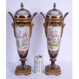 A LARGE PAIR OF 19TH CENTURY FRENCH SEVRES PORCELAIN VASES AND COVERS painted with lovers within lan