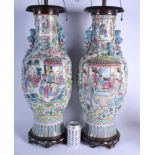 A LARGE 19TH CENTURY CHINESE CANTON FAMILLE ROSE VASES Qing, converted to lamps, painted with figure